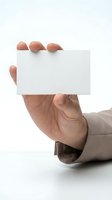 Male hand holding blank white business card mockup for branding and corporate identity design projects on clean background.