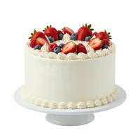 Elegant cream cake topped with fresh strawberries and blueberries on white cake stand, isolated on white background for bakery, dessert, and celebration design projects.