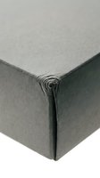 Close-up corner detail of dark green leather material showing texture and craftsmanship for luxury goods and upholstery applications.