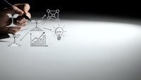 Hand drawing business strategy icons with pen on white paper showing growth charts lightbulb and network connections for corporate planning presentations.