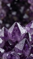 Purple amethyst crystal formations with water droplets showcasing natural mineral beauty and healing stone properties for wellness and meditation practices.