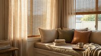 Cozy living room interior with warm sunlight streaming through bamboo blinds onto neutral sofa with decorative pillows creating peaceful home atmosphere.