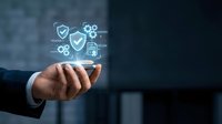Businessman hand holding digital security icons with shield and gear symbols, representing data protection and cybersecurity solutions for enterprise systems.