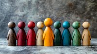 Colorful wooden figures standing in row symbolizing diversity, inclusion and teamwork. Social unity concept shown through rainbow-colored pawns against textured background.