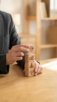 Business professional stacking wooden blocks with psychology symbols representing mental health concepts and cognitive development strategies.