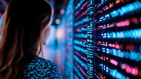 Young woman looking at glowing digital data wall with streaming numbers and code in blue and pink neon lights, representing technology and cybersecurity concepts.