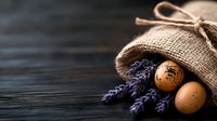 Rustic burlap sack with fresh brown eggs and dried lavender sprigs on dark wooden background for natural organic farm products and cooking concepts.