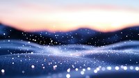 Dreamy winter landscape with glowing snowflakes floating in cold air against purple sunset sky and snowy hills, creating magical atmospheric scenery.