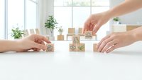 Hands arranging wooden blocks with ESG symbols on white desk in bright office environment representing sustainable business practices and corporate responsibility.