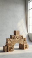 Wooden building blocks with business icons arranged in bridge formation on white surface near window with natural sunlight creating shadows.