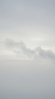 Soft gray overcast sky with fluffy white clouds creating dreamy atmospheric background for weather forecasts and nature projects.