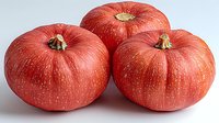 Fresh ripe red pumpkins with smooth skin and natural texture isolated on white background, organic farm harvest for seasonal cooking and decoration.