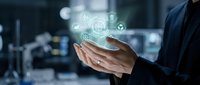 Businessman holding holographic digital technology icons in palm showcasing innovation and futuristic business solutions in modern office environment.