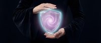 Businessman hands protecting glowing digital security shield with spiral pattern on dark background for cybersecurity and data protection concepts.