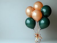 Festive bunch of peach and dark green metallic balloons tied with golden ribbon bow against light gray background, modern party decoration.