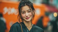 Young Asian woman with wet hair smiling confidently in urban evening setting with warm bokeh lights and vibrant city atmosphere for lifestyle content.