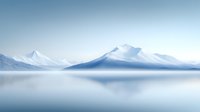 Minimalist winter landscape with snow-covered mountain peaks reflected in calm misty lake waters, creating serene symmetrical composition in soft blue tones.
