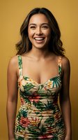 Happy young Hispanic woman in tropical floral dress smiling warmly against golden yellow background for summer fashion and lifestyle content.
