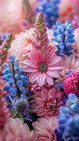 Vibrant spring garden flowers featuring pink dahlias, blue grape hyacinths, and osteospermum in dreamy soft focus. Perfect for romantic greeting cards, wedding invitations, and floral design projects.