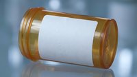 Transparent cylindrical battery cell with white label on reflective surface against blurred blue background for energy storage and power technology concepts.