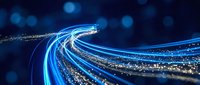 Abstract flowing light trails in shades of blue and white swirl across dark background, creating dynamic motion effect. Suitable for technology, digital transformation, data flow, and modern business concepts.