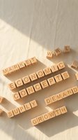 Wooden letter blocks spelling business and economic terms on neutral background with natural lighting for educational content.