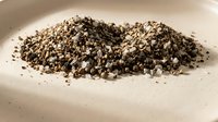 Organic vermiculite mineral aggregate pile for gardening and horticulture applications. Natural lightweight soil amendment for plant cultivation and growing.
