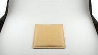 Brown kraft paper square envelope on white background isolated for postal mailing correspondence and office stationery design projects.