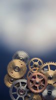 Vintage brass and copper clockwork gears and cogs arranged on dramatic blue gradient background for steampunk mechanical design projects.