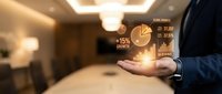 Businessman holding glowing financial charts and pie graphs in palm, displaying growth statistics and market data analytics for business planning and investment strategy.