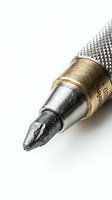 Close-up of soldering iron tip with brass and silver metal components on white background, isolated tool for electronics repair and welding work.