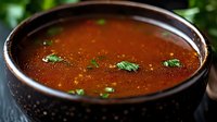 Rich tomato soup with fresh herbs in ceramic bowl, homemade comfort food for restaurant menu and culinary content.
