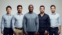 Diverse group of five professional men standing together in casual business attire representing teamwork and workplace diversity.