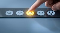 Customer selecting happy face emoji on satisfaction rating scale, finger touching glowing smiley icon for feedback survey or service review.