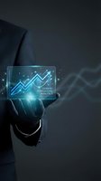 Businessman in dark suit holding glowing tablet displaying upward trending arrows and demand forecasting analytics data visualization for business growth and market analysis.