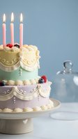 Elegant two-tier birthday cake with pink candles, buttercream roses and berries on pastel green and lavender layers for celebration and party events.