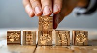 Wooden blocks with innovation and brainstorming icons arranged in row showing brain, lightbulb and strategy symbols for business concept and creative thinking process.