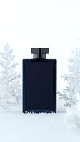Navy blue glass cologne bottle on snow with frosted winter branches background, luxury fragrance product photography for advertising and marketing campaigns.