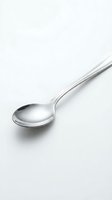 Stainless steel spoon isolated on white background for kitchen utensil design and culinary projects.