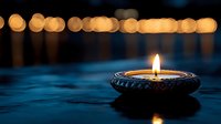 Floating oil lamp with warm flame on water surface creating peaceful ambiance with golden bokeh lights in background for meditation and relaxation.