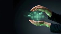 Business hands protecting glowing financial data charts and graphs with green light effects on dark background for corporate presentations.