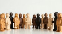 Wooden figurines in various natural and dark stains arranged in a row, representing diversity and teamwork for community, business, and organizational concepts.