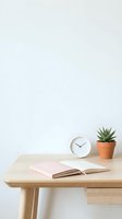 Minimalist wooden desk with open pink notebook, white round clock, and potted succulent plant against white wall for workspace and office design projects.