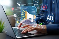 Digital marketing concept with businessman hands over laptop displaying floating holographic icons including megaphone, social media symbols and AD text for advertising campaigns.