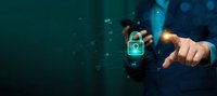 Businessman touching digital security lock icon with glowing network connections and data protection symbols on dark blue technology background.