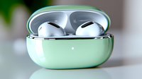 Mint green wireless earbuds in open charging case on white surface with soft natural lighting for modern technology and audio accessories.