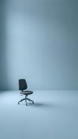 Black office chair with wheels positioned in minimalist empty room with soft blue-gray walls and white floor, suitable for corporate workspace, job recruitment, and business concepts.