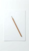 Wooden pencil with sharp tip resting diagonally on blank white paper sheet against neutral background, suitable for education, creativity, writing, and design concepts.