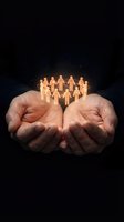 Cupped hands holding glowing wooden figures in circle representing community support, teamwork, human resources, social responsibility and care.