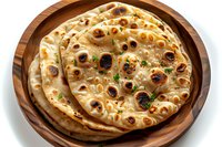 Fresh homemade naan bread with charred spots and herbs served on wooden plate, traditional Indian flatbread perfect for restaurant menu, food photography or culinary blog.